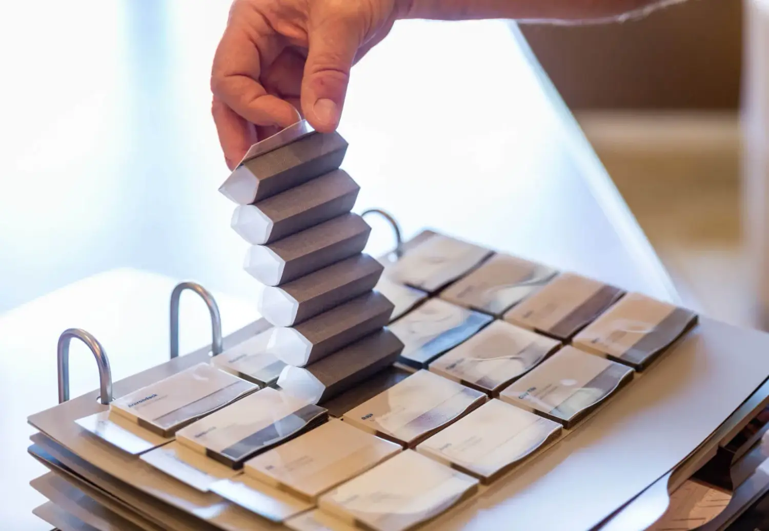 in home design consultation showing samples of window shutters to young couple