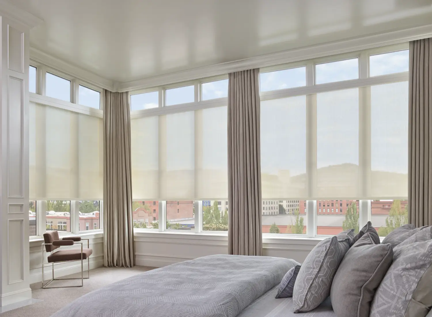 solar shades on large windows in corner bedroom